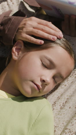 a girl taking a nap while someone reads
