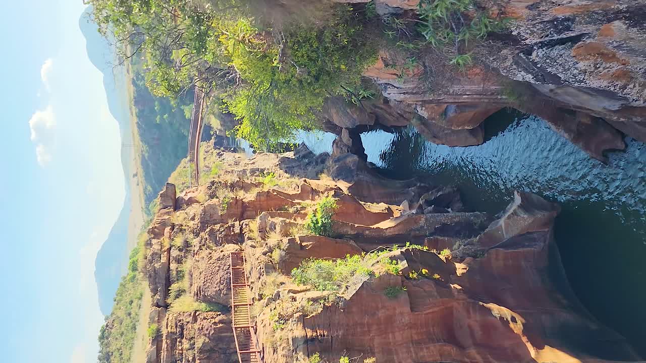 Vertical pan from rocky cliffs above Burke&rsquo;s Potholes, Blyde Canyon, South Africa