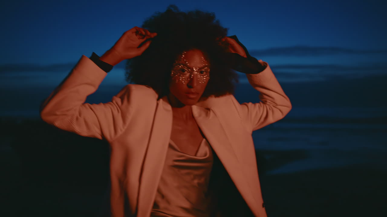 Fashion model dancing dark seashore. Closeup   spinning night