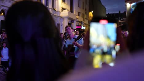 street musician playing guitar at night