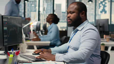 day trader in brokerage company office analyzes stock market trends