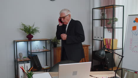 angry senior business man making phone call at office work annoyed boss talking mobile quarrel