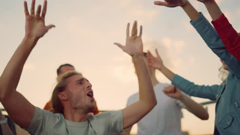 een gelukkige man die op een dakfeestje danst, emotionele mensen op een disco.