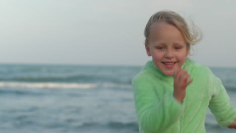 happy kid running against ocean background