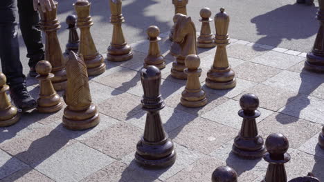 people playing and watching giant chess strategy game in public park of lugano 4k