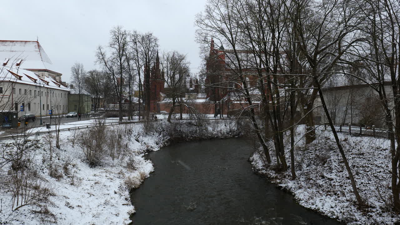 Snow Falling on St Annes Church Vilnius Viewed from Vilnia River Lithuania