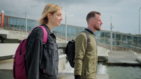 couple walking through urban water feature