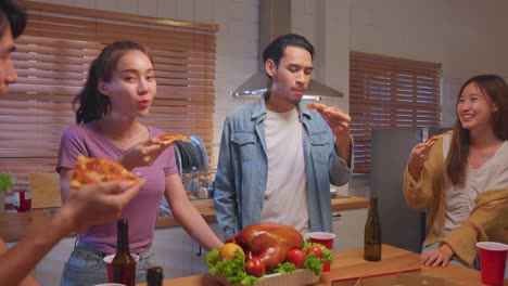 friends enjoying pizza and drinks in a cozy kitchen