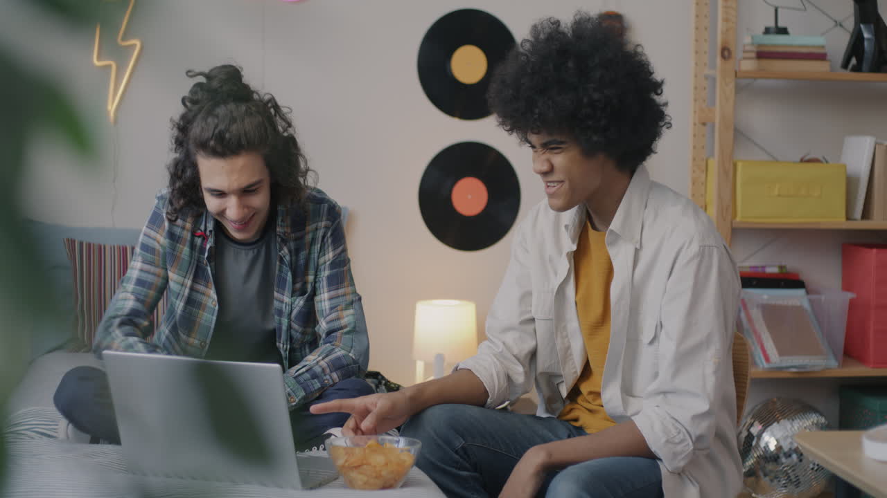 Two Teen Boys Watching a Video on Laptop