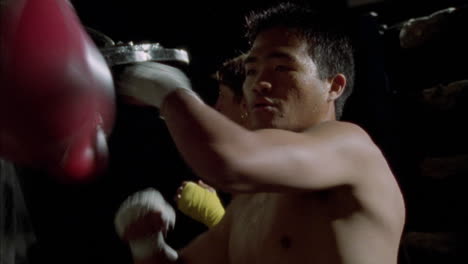 a couple of boxers work out on speed bags 1