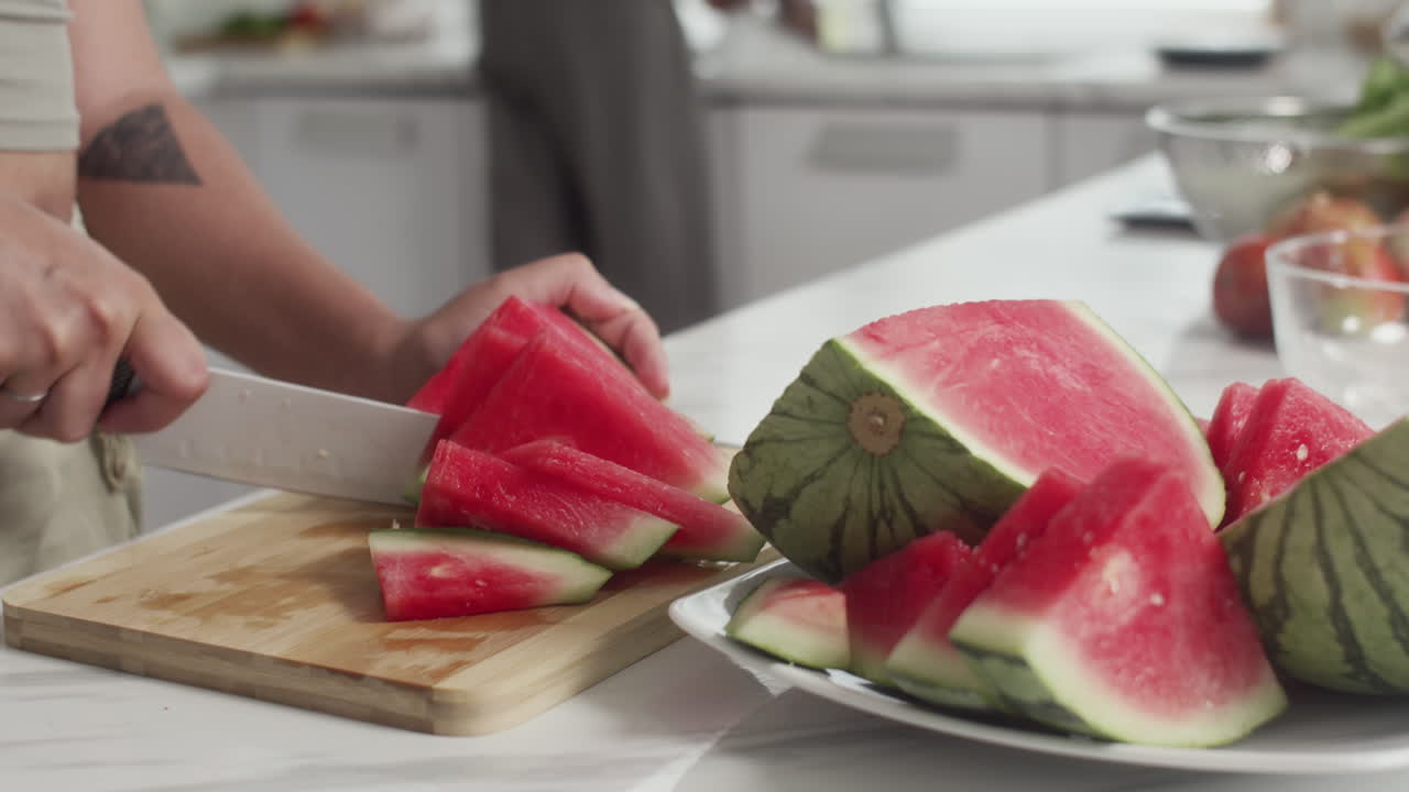 Girl Slicing Watermelon Cooking Together with Friend at Home