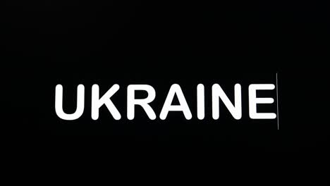 typing the letters of ukraine in uppercase and boldface as shown on a black background of the computer screen