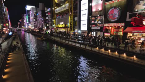 illuminated cityscape along a bustling canal