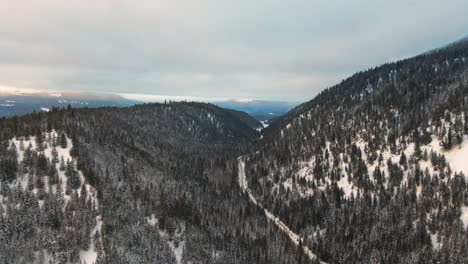 Mystic-Winter:-Beautiful-Drone-Pullback-Shot-of-Cloudy,-Foggy-Tree-Covered-Mountains-in-the-Thompson-Nicola-Region,-BC,-Canada