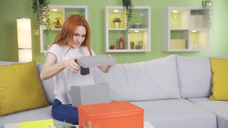 happy young woman opening gift boxes rejoices.