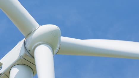 extreme close-up of a wind turbine rotating and producing green, clean energy