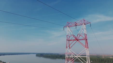 high voltage transmission tower over a river