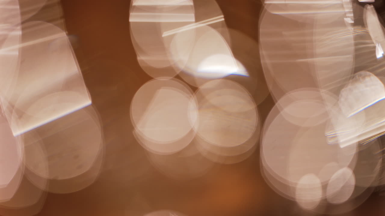 Abstract composition of light trails and overlapping bokeh in warm golden tones