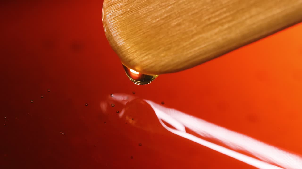 Honey or Syrup Dripping from a Wooden Dipper