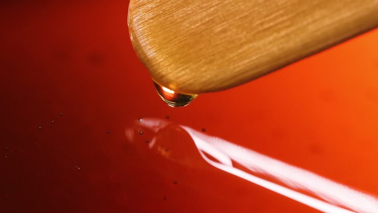 Honey or Syrup Dripping from a Wooden Dipper