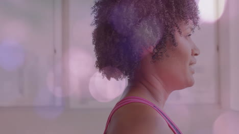 profile of woman with curly hair over pink bokeh lights animation