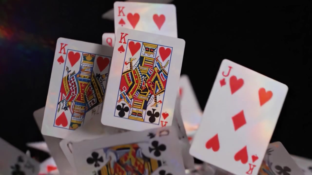 An Exciting Moment in Card Tricks: Capturing the Thrilling Flight of Playing Cards in a Mysterious Dark Setting with Vibrant Reflections and Sparkling Colors