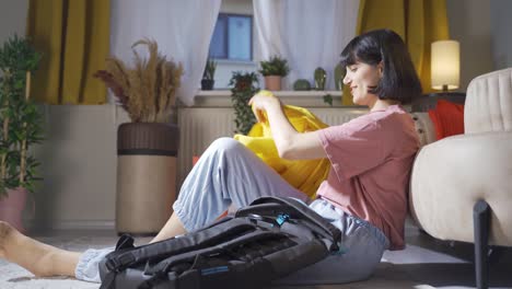 woman preparing bags for travel at home.