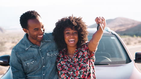 Young-black-having-roadside-stop-off,-woman-waving-car-keys