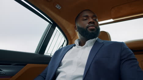 Portrait-of-afro-businessman-dancing-at-car.-Business-man-counting-money-at-car