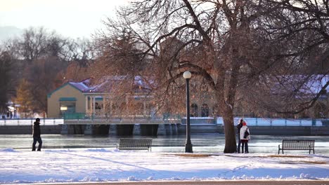 people spending time in the city park against a background of denver skyline