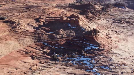 Rocky-cliffs-with-snow-on-slopes-on-sunny-day-in-valley