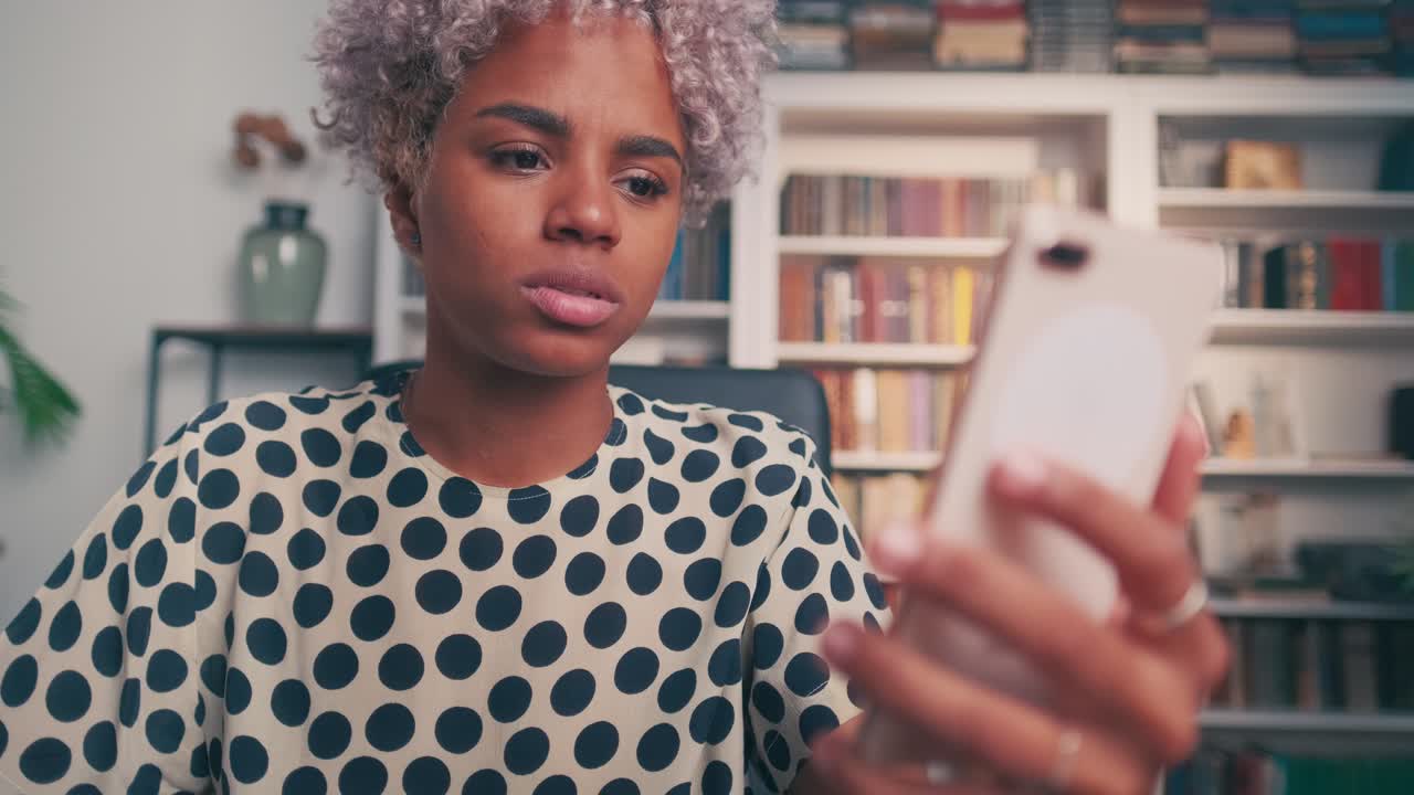 Excited attractive woman with mobile phone receives notification of winning