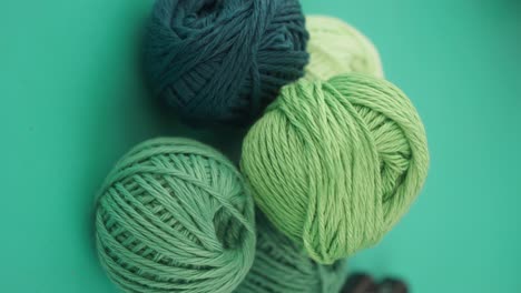 green yarn skeins and knitting needles