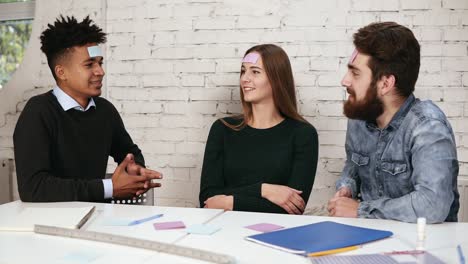 diverse business team playing games in the office. the company of friends having fun in the office. young people pasted pieces