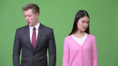 young asian woman and young businessman thinking together