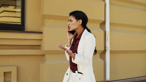 worried business woman having phone conversation outside