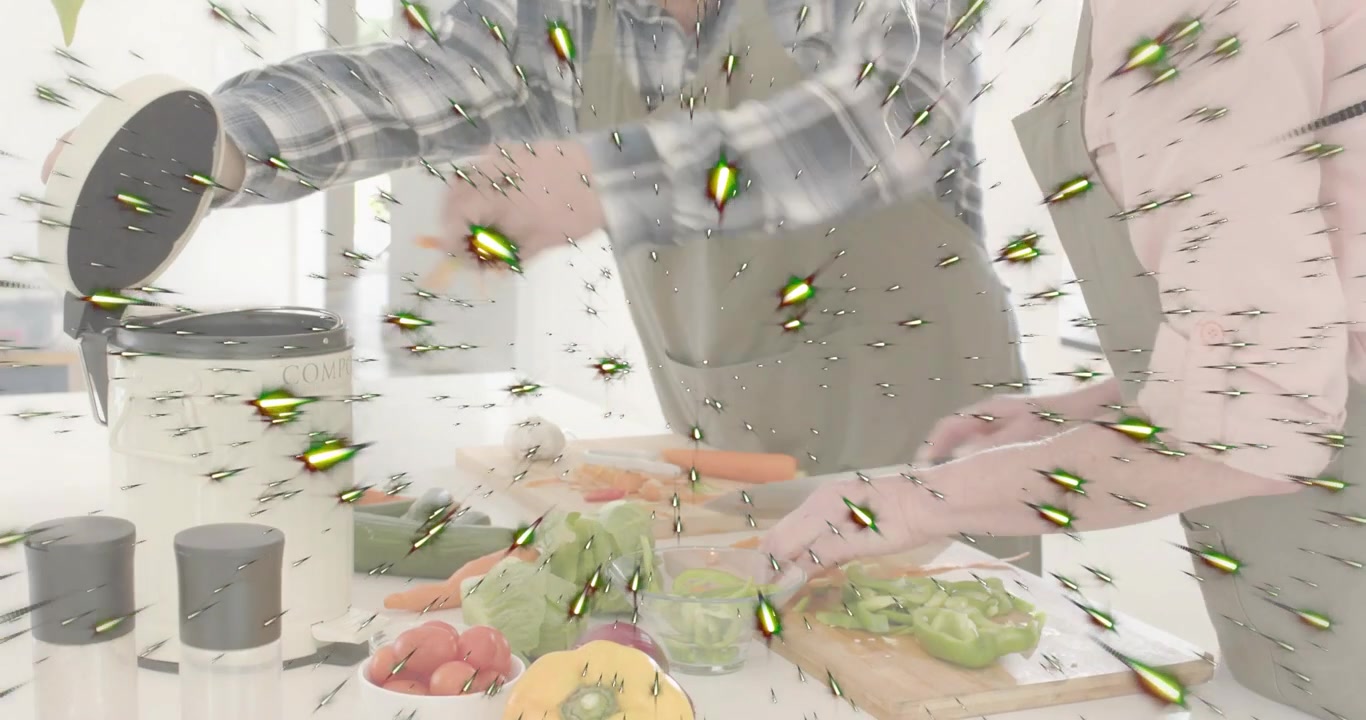 男性が蒸し器に水を注ぎ、女性が野菜を刻み、蒸し料理の準備をしている。