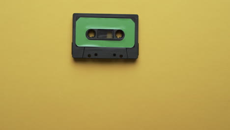 video of retro tape with green label with copy space on yellow background