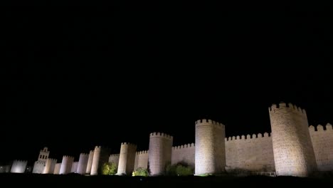 a night panoramic shot of avila’s ancient old town, featuring the illuminated medieval walls, a unesco world heritage site in spain.