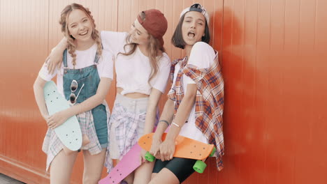 three friends enjoying summer day out with skateboards