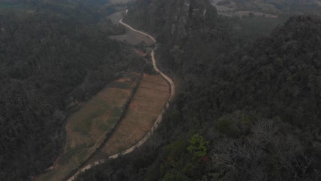 Motorbike-is-parked-on-top-of-viewpoint-at-vang-vieng-Laos,-aerial