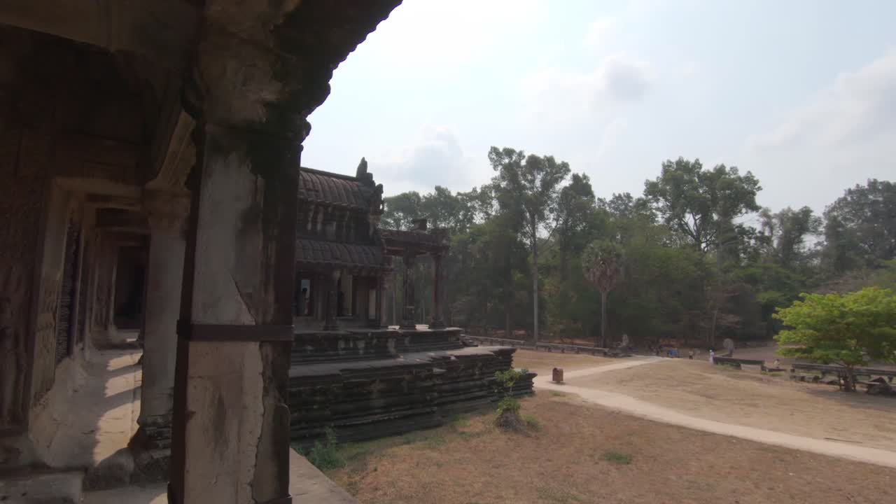 Slow pan out of a gallery window in Angkor Wat, Cambodia