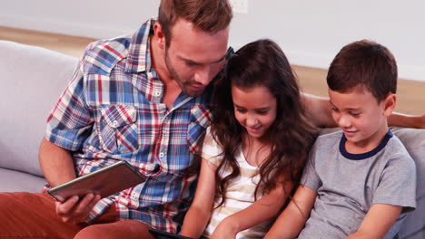 Happy-father-with-two-children-using-tablets