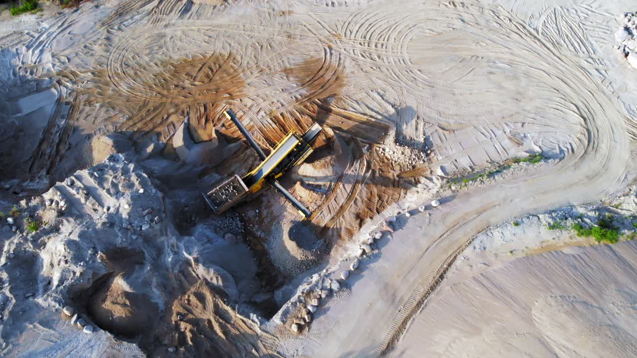 Aerial orbit shot from a drone of quarry and heavy machinery in pomeranian district in Poland