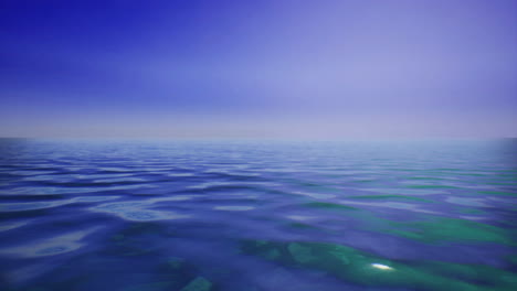vast calm ocean under a tranquil blue sky with soft waves