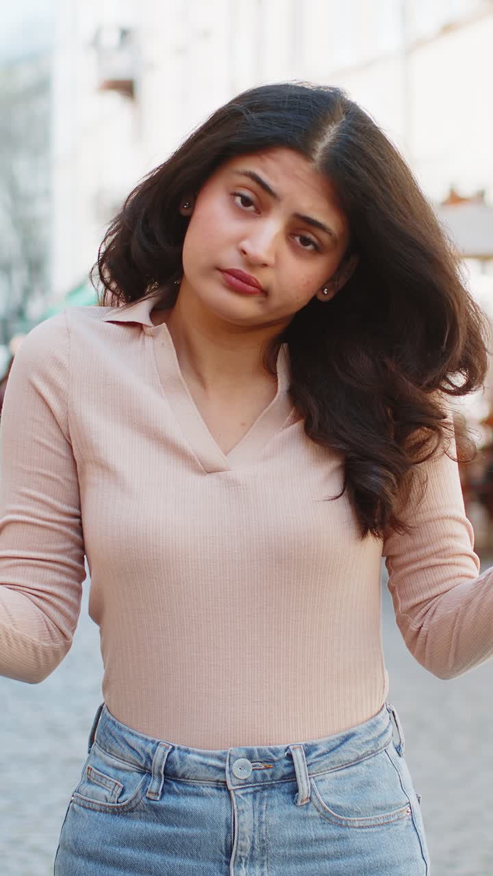 Surprised frustrated indian woman raising hands asking reason of failure demonstrating disbelief