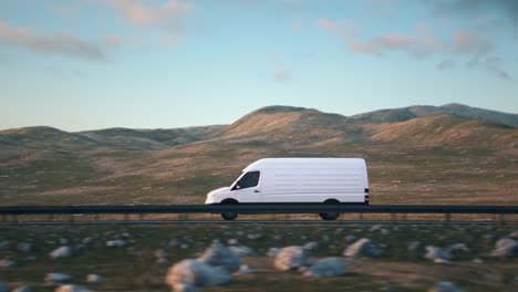 white delivery van driving along a desert road into the sunset