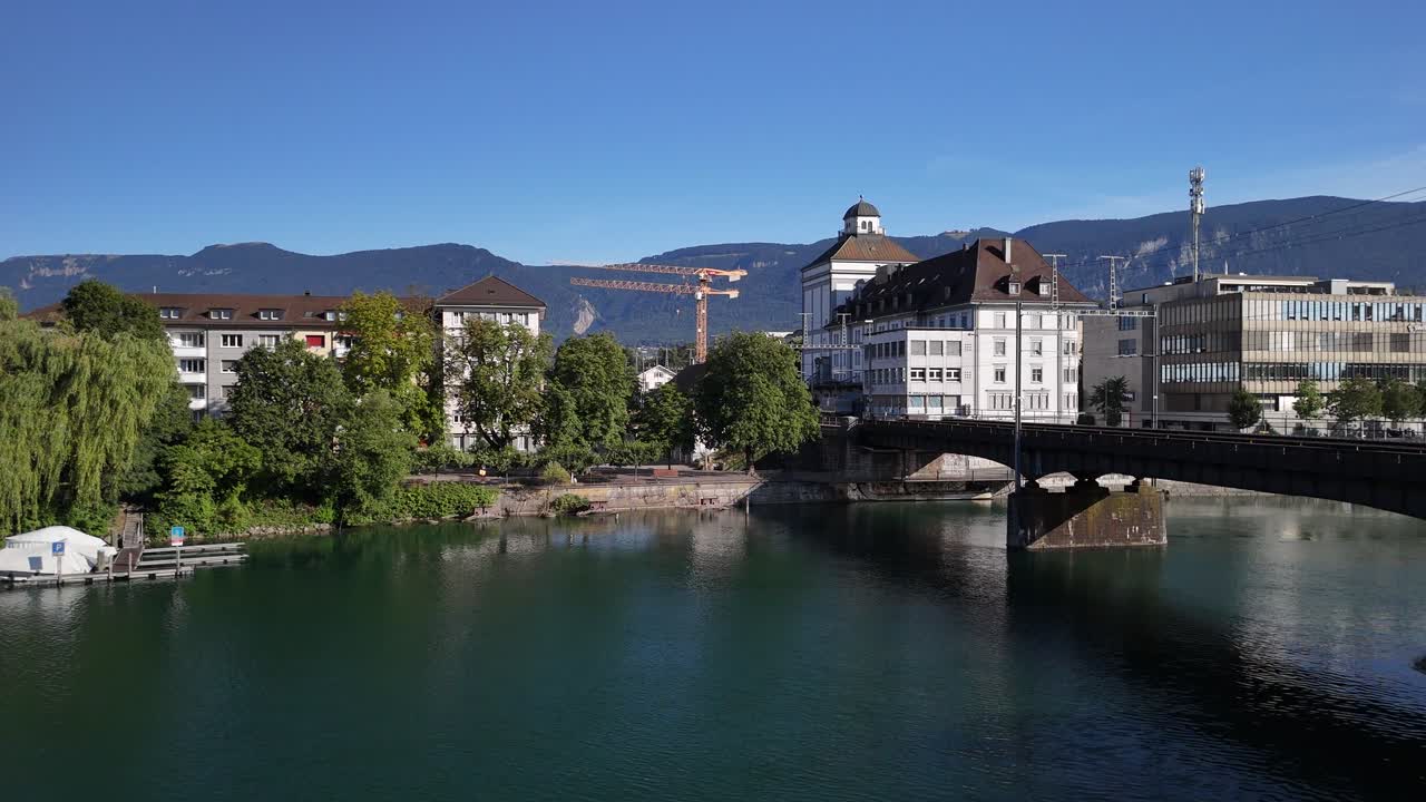 Cityscape with River, Bridge, and Mountains