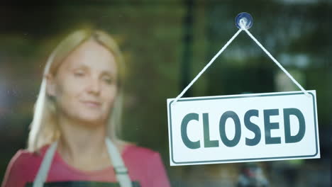 the female seller turns the tablet that says closed to open beginning of the day open your business