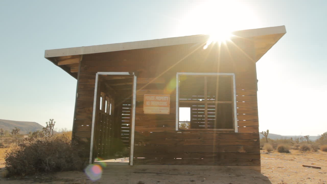 small shack-structure in the desert_lens flare